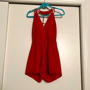 Red romper with shorts. Open back and deep v neck.